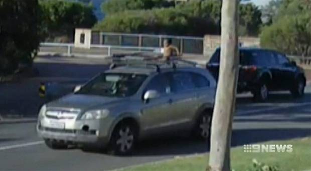 Crazy footage shows a mother driving with her son sitting on the roof rack!